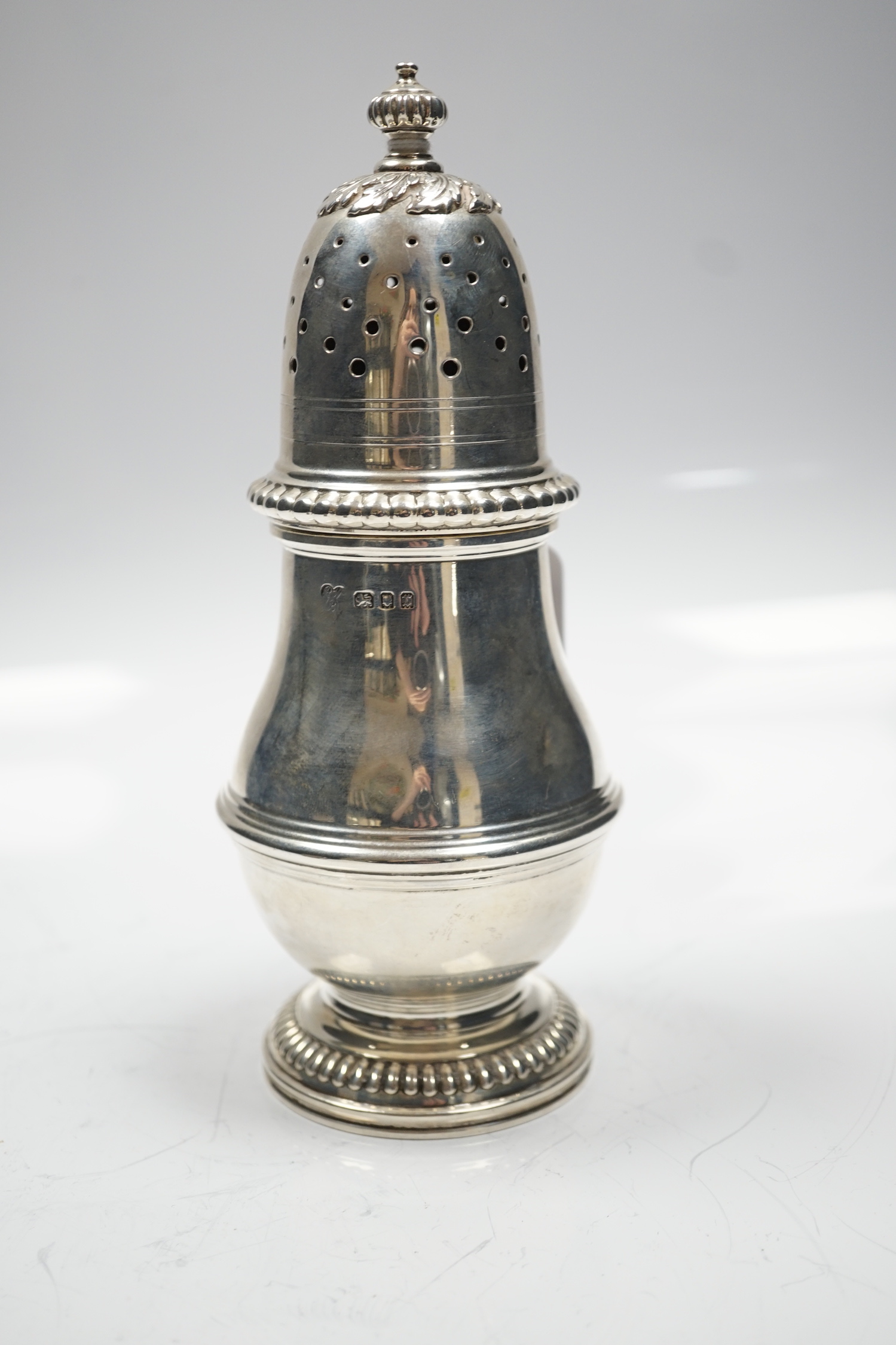 A George V silver baluster sugar caster, Harrod's Ltd, London, 1931, 20.2cm, 9.8oz.